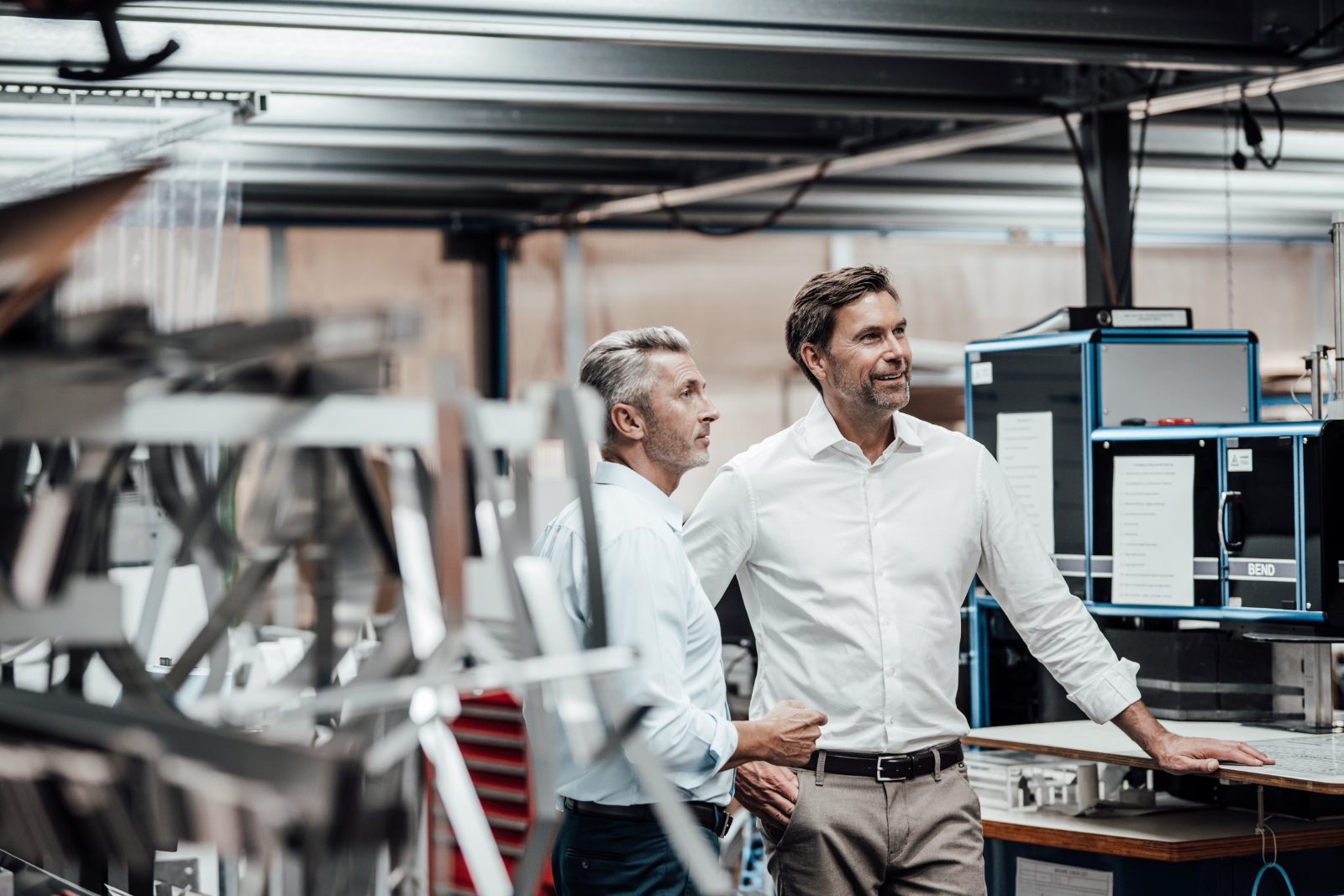 Two business partners touring their manufacturing facility